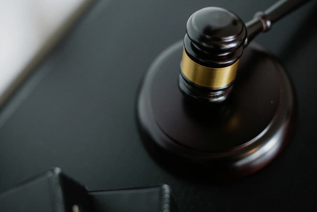 A close-up of a judge's gavel on a desk