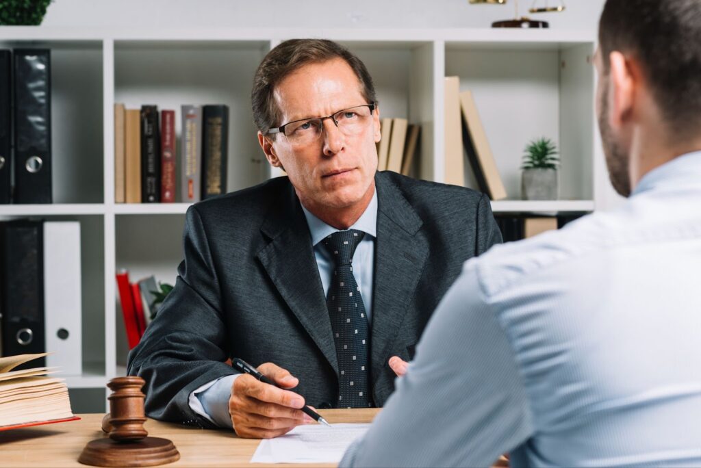 Mature lawyer with clients in a meeting