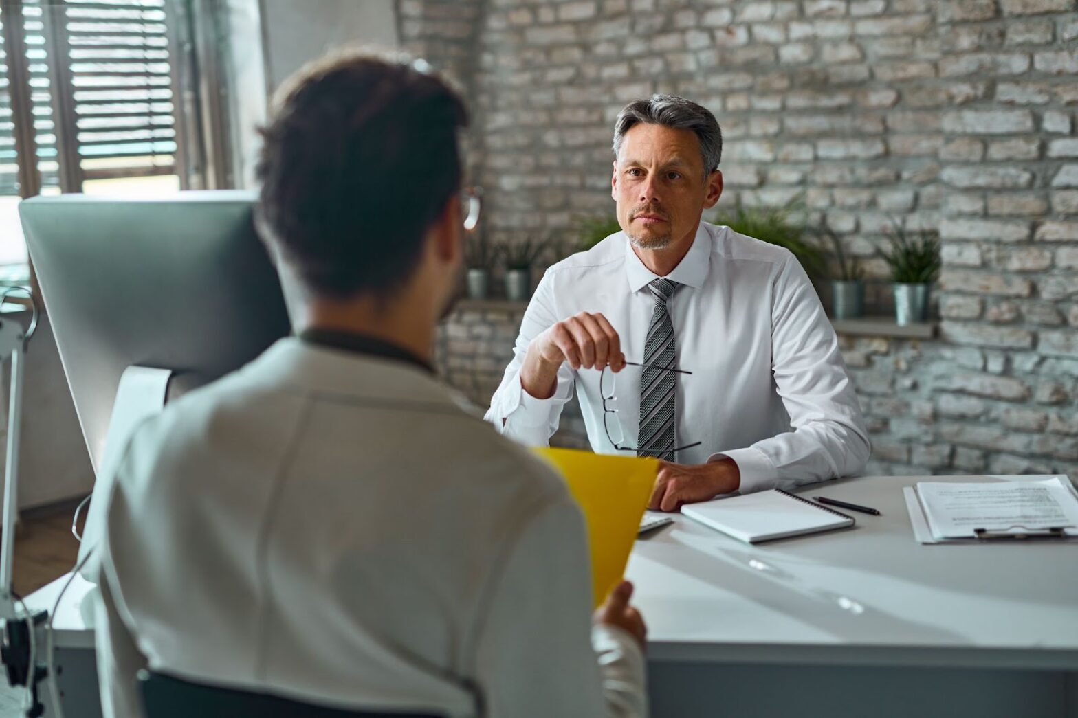 Member of human resource team having job interview with a candidate in the office