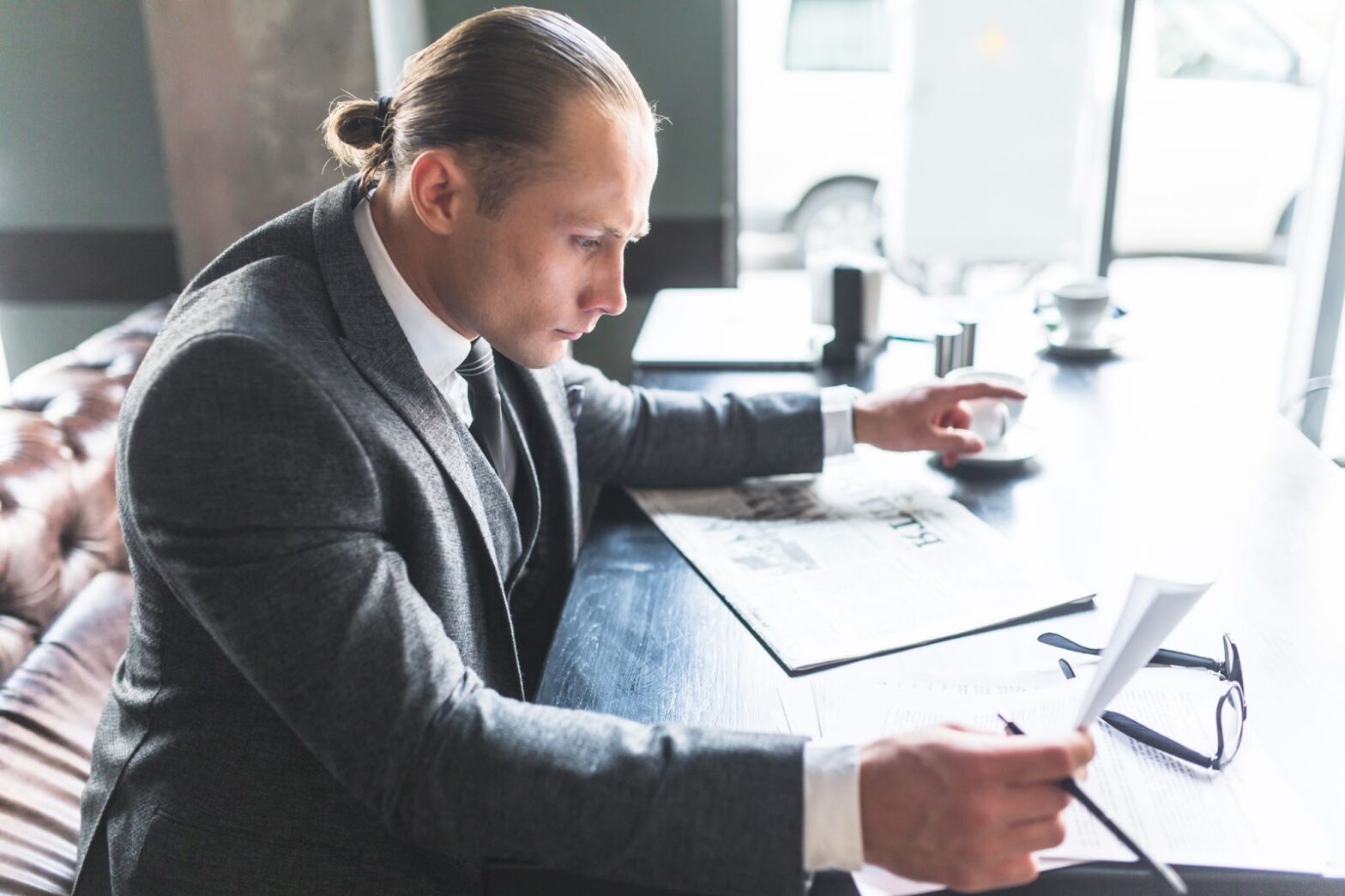 Side view of a businessman checking document