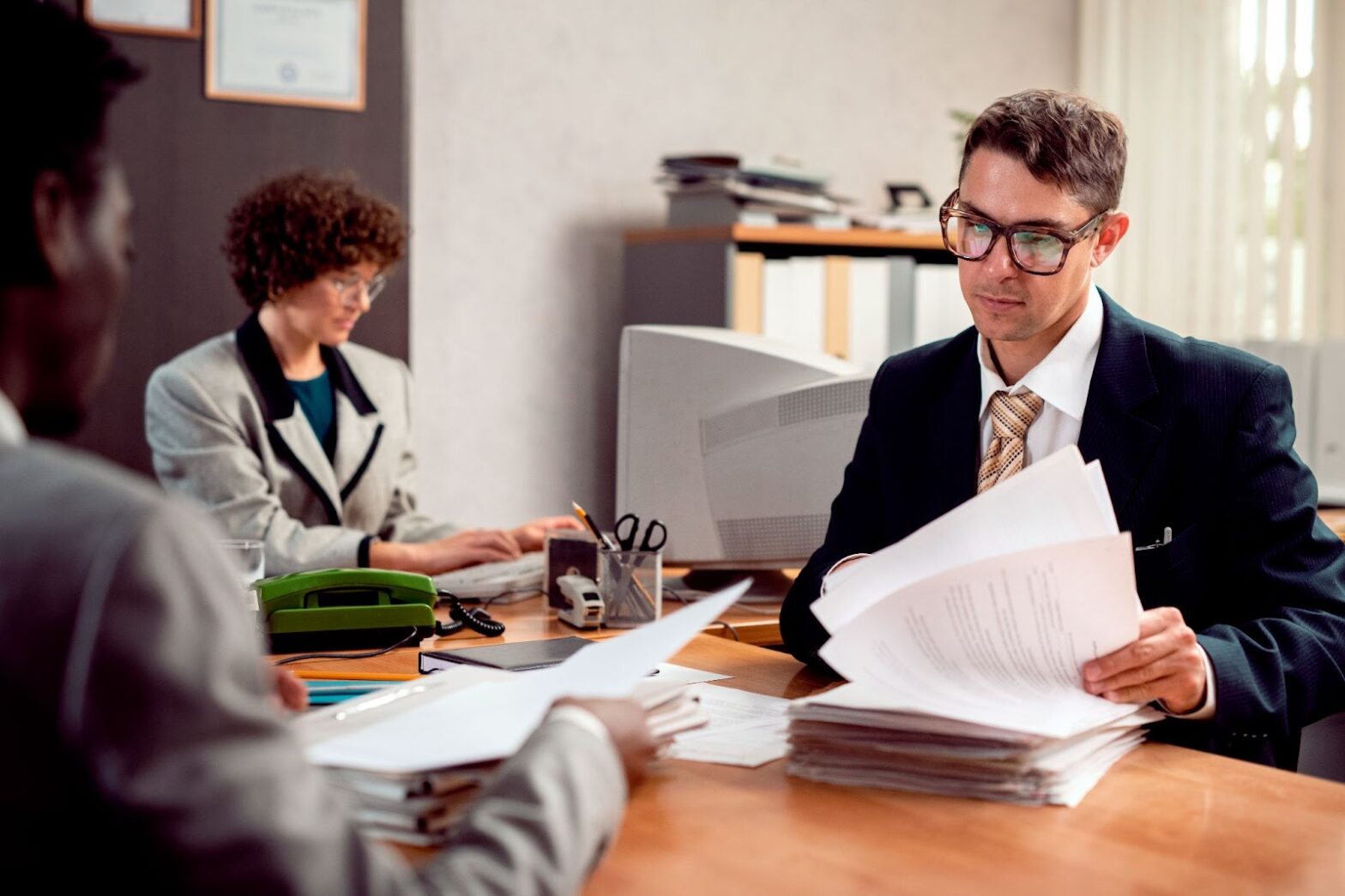 People working in an office with computers and documents
